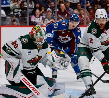 Wild goaltender Jesper Wallstedt stops a puck at the post as defenseman Jeff Petry clears the rebound.