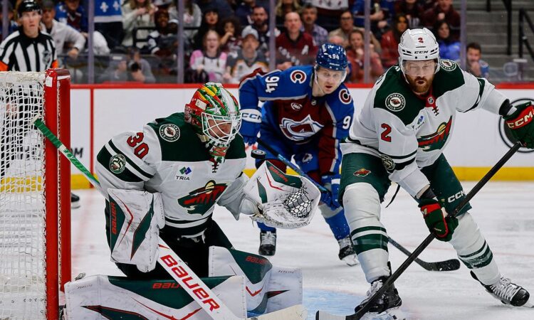 Wild goaltender Jesper Wallstedt stops a puck at the post as defenseman Jeff Petry clears the rebound.