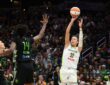 Dallas Wings forward Jessica Shepard releases a jump shot as Seattle Storm defenders reach to contest.