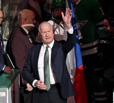 Dallas Stars general manager Jim Nill raises a hand to the crowd during a pregame ceremony.