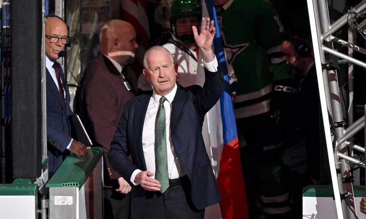 Dallas Stars general manager Jim Nill raises a hand to the crowd during a pregame ceremony.