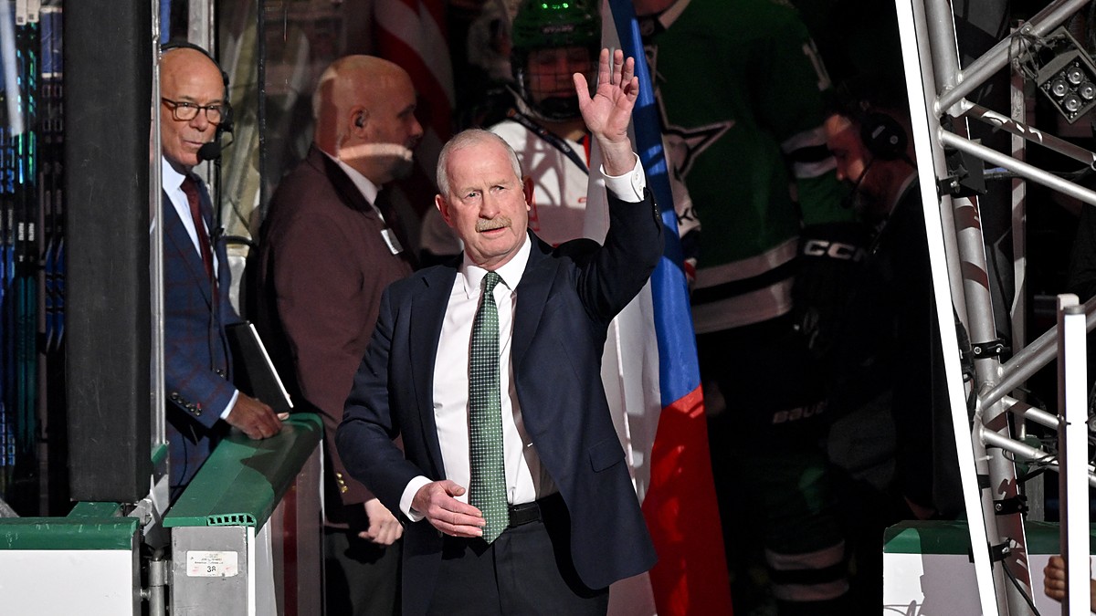 Dallas Stars general manager Jim Nill raises a hand to the crowd during a pregame ceremony.