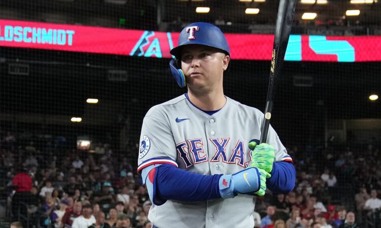 Texas Rangers designated hitter Joc Pederson holds his bat up as he waits to step in against Arizona.