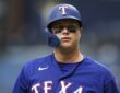 Rangers designated hitter Joc Pederson looks on in his batting helmet during the game against the Rays.