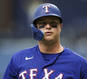 Rangers designated hitter Joc Pederson looks on in his batting helmet during the game against the Rays.