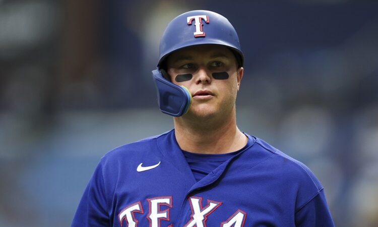 Rangers designated hitter Joc Pederson looks on in his batting helmet during the game against the Rays.