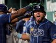 Tampa Bay Rays first baseman Jonathan Aranda shouts in the dugout as a teammate reaches for his helmet.