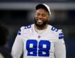 Dallas Cowboys defensive tackle Jonathan Bullard smiles on the field in his white jersey before a game at AT&T Stadium.