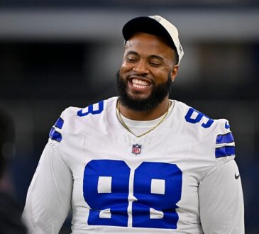 Dallas Cowboys defensive tackle Jonathan Bullard smiles on the field in his white jersey before a game at AT&T Stadium.