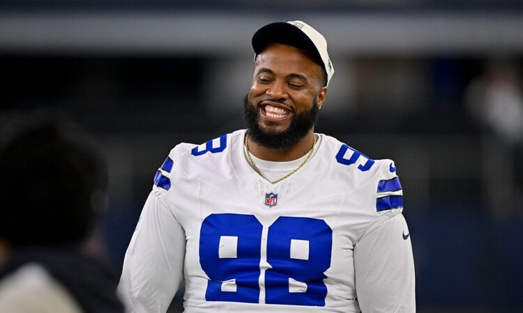 Dallas Cowboys defensive tackle Jonathan Bullard smiles on the field in his white jersey before a game at AT&T Stadium.