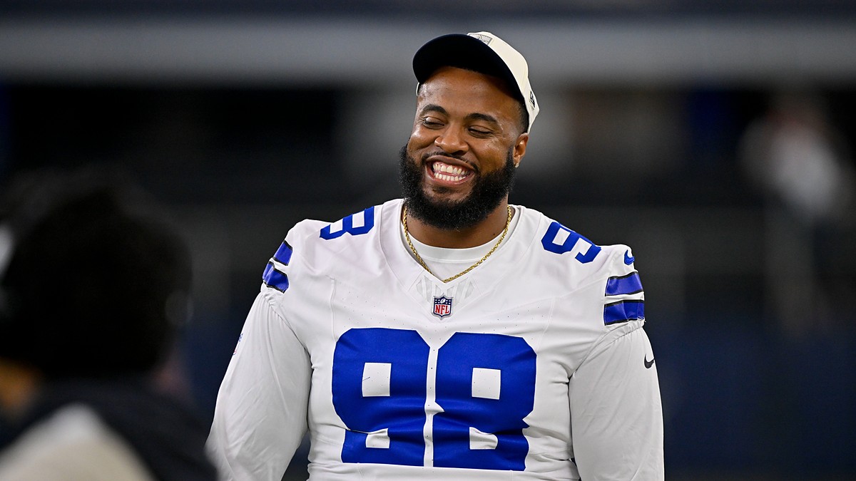 Dallas Cowboys defensive tackle Jonathan Bullard smiles on the field in his white jersey before a game at AT&T Stadium.