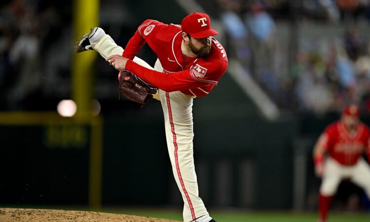 Texas Rangers pitcher Jordan Montgomery follows through off the mound with his back leg kicked high.