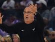 Dallas Wings head coach Jose Fernandez raises both hands as he reacts from the sideline.