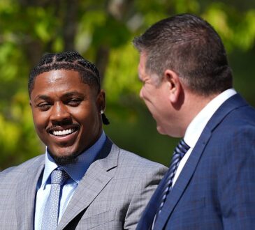 Green Bay Packers running back Josh Jacobs walks outside the courthouse alongside his attorney.