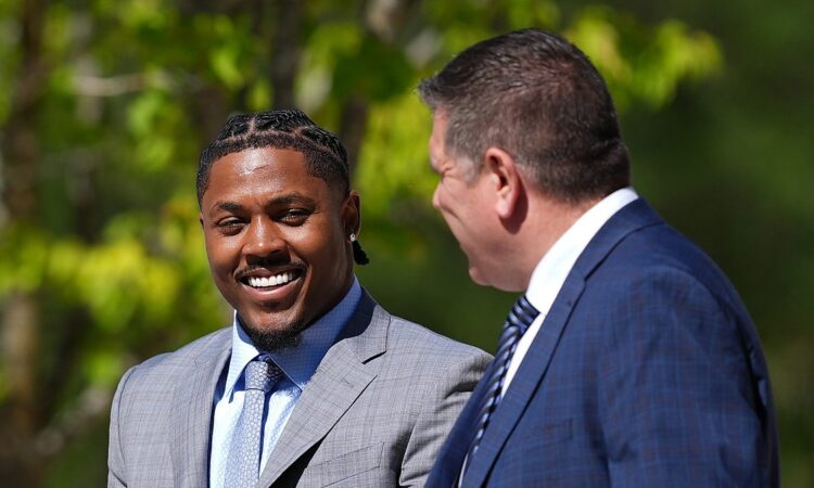 Green Bay Packers running back Josh Jacobs walks outside the courthouse alongside his attorney.
