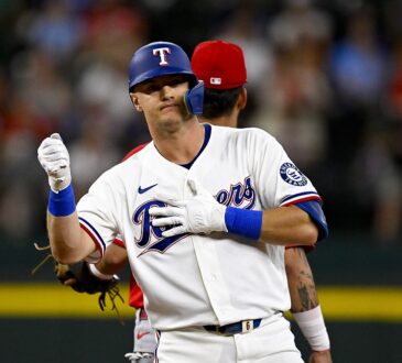 Texas Rangers third baseman Josh Jung pumps a fist at second base after hitting a double against the Angels.
