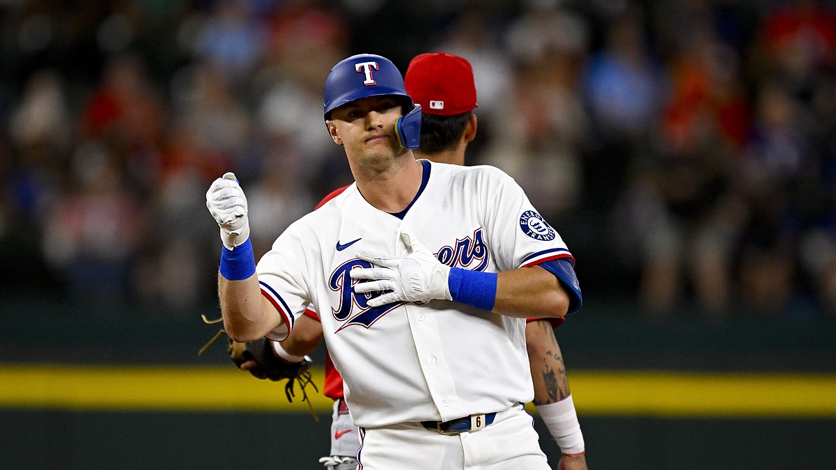 Texas Rangers third baseman Josh Jung pumps a fist at second base after hitting a double against the Angels.