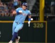 Texas Rangers third baseman Josh Jung, No. 6, sprints toward third base in a powder blue uniform.