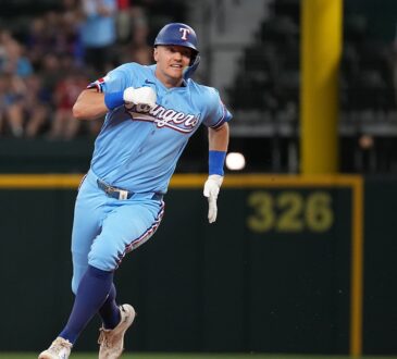 Texas Rangers third baseman Josh Jung, No. 6, sprints toward third base in a powder blue uniform.