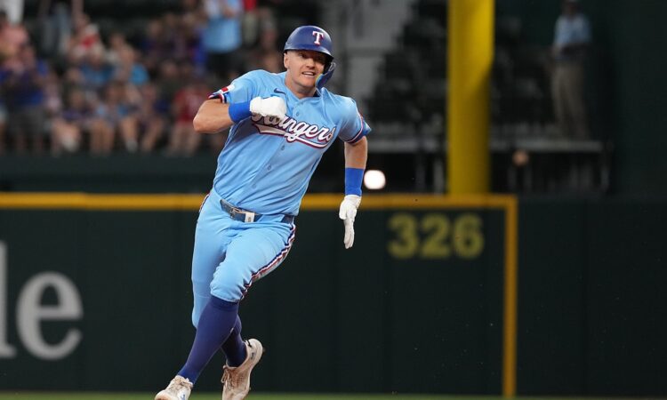 Texas Rangers third baseman Josh Jung, No. 6, sprints toward third base in a powder blue uniform.
