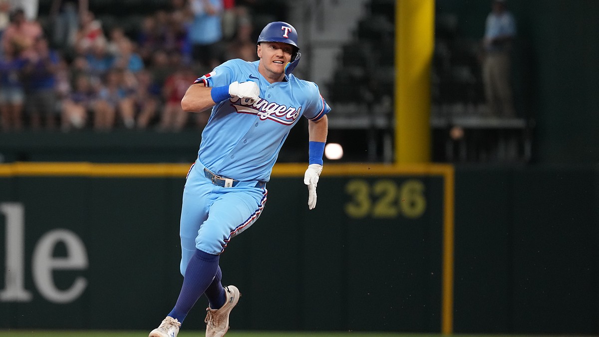 Texas Rangers third baseman Josh Jung, No. 6, sprints toward third base in a powder blue uniform.