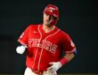 Texas Rangers third baseman Josh Jung jogs the bases in his red Tejas jersey after hitting a home run.