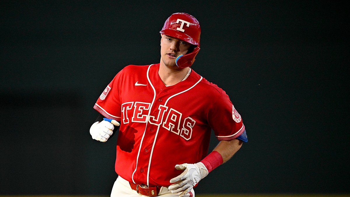 Texas Rangers third baseman Josh Jung jogs the bases in his red Tejas jersey after hitting a home run.