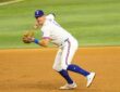 Rangers third baseman Josh Jung sets to throw to first base with the ball in his right hand.