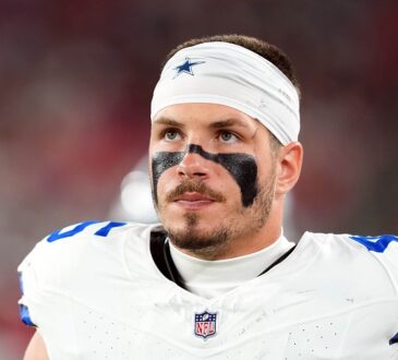 Dallas Cowboys linebacker Justin Barron, wearing eye black and a Cowboys headband, looks up during a game.