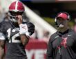 Alabama quarterback Keelon Russell stands beside offensive coordinator Ryan Grubb, who wears a headset, during a spring practice.