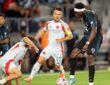 Minnesota United forward Kelvin Yeboah strikes the ball as FC Dallas midfielder Ran Binyamin slides in to block.