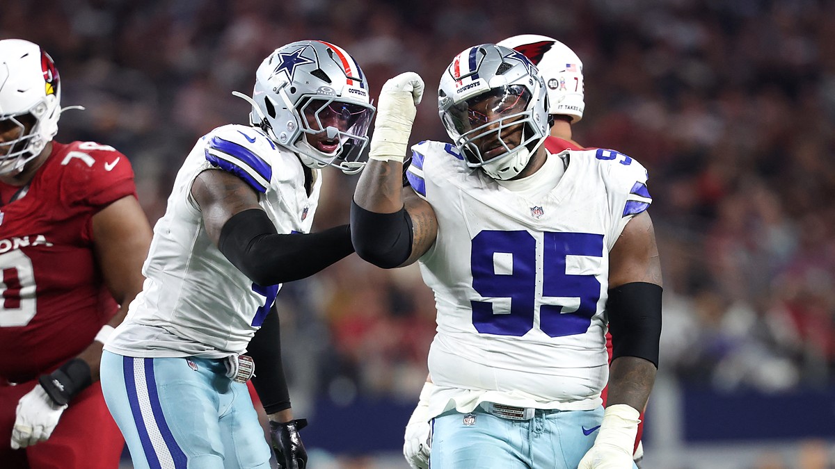 Dallas Cowboys defensive tackle Kenny Clark raises a fist beside defensive end Donovan Ezeiruaku after a sack.