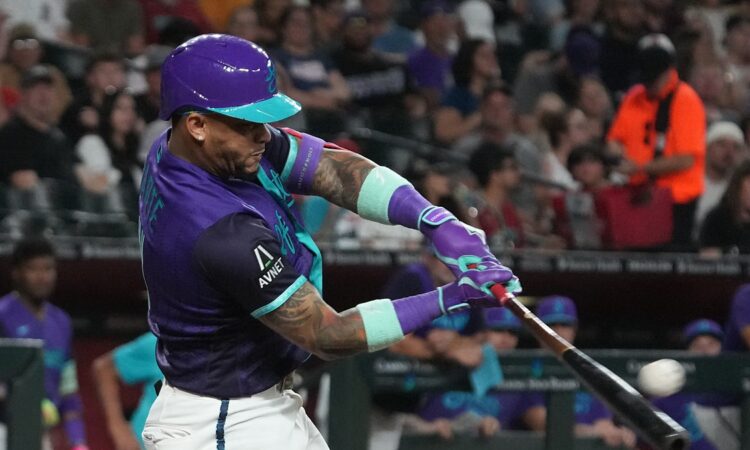 Arizona Diamondbacks second baseman Ketel Marte drives through his swing as the ball comes off the bat.
