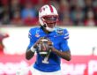 SMU Mustangs quarterback Kevin Jennings, No. 7, sets to throw with both hands on the ball.