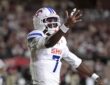 SMU Mustangs quarterback Kevin Jennings spreads his arms and reacts during the first half against Florida State.