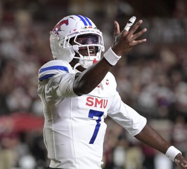 SMU Mustangs quarterback Kevin Jennings spreads his arms and reacts during the first half against Florida State.