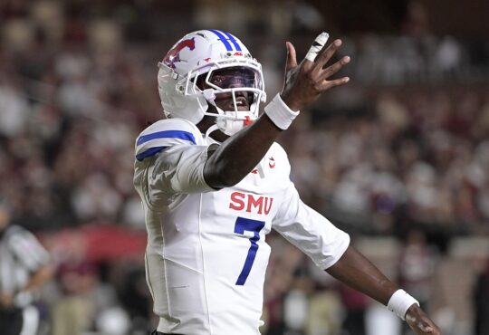 SMU Mustangs quarterback Kevin Jennings spreads his arms and reacts during the first half against Florida State.