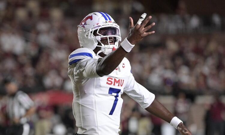 SMU Mustangs quarterback Kevin Jennings spreads his arms and reacts during the first half against Florida State.