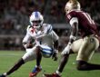 SMU Mustangs quarterback Kevin Jennings tucks the ball and cuts back as a Florida State defender closes in.