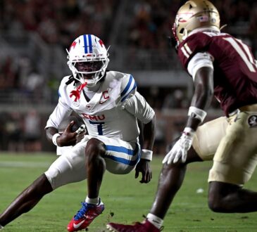SMU Mustangs quarterback Kevin Jennings tucks the ball and cuts back as a Florida State defender closes in.