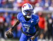 SMU Mustangs quarterback Kevin Jennings, No. 7, carries the ball in his right hand while running.