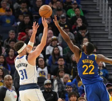 Dallas Mavericks guard Klay Thompson #31 shoots against Golden State Warriors forward Andrew Wiggins #22 at Chase Center.