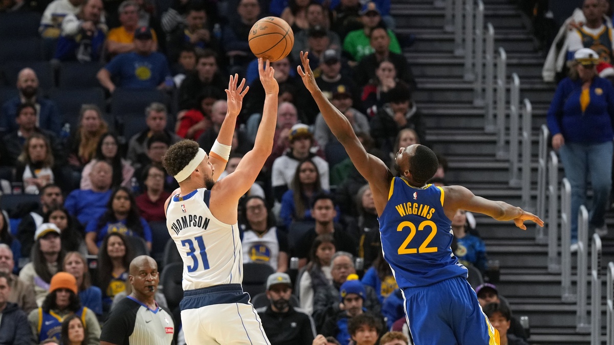 Dallas Mavericks guard Klay Thompson #31 shoots against Golden State Warriors forward Andrew Wiggins #22 at Chase Center.