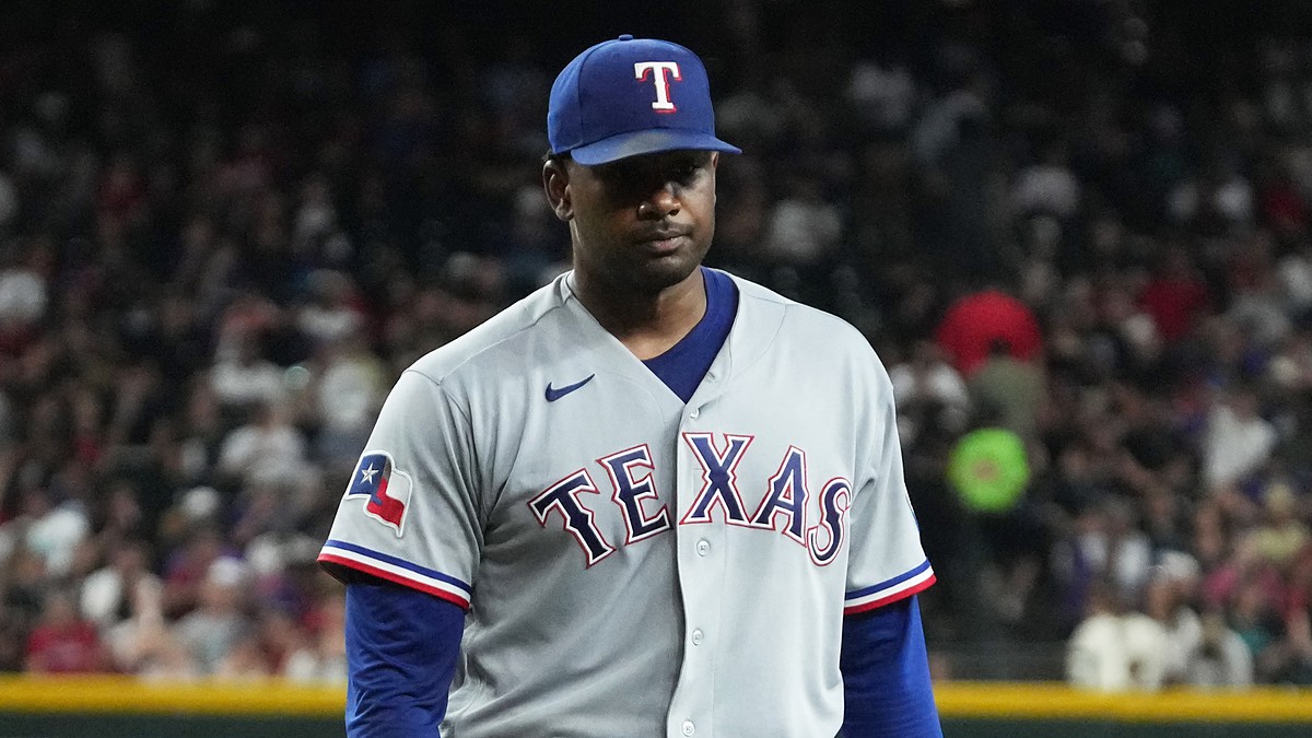 Texas Rangers pitcher Kumar Rocker walks off the field with a flat expression after the first inning.