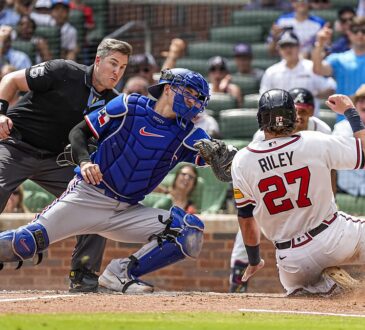 Texas Rangers catcher Kyle Higashioka, No. 11, applies a tag on sliding Atlanta Braves third baseman Austin Riley.