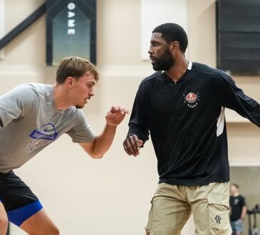 Dallas Mavericks guard Kyrie Irving dribbles to his left as forward Cooper Flagg defends during a workout.