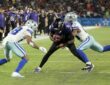 Cowboys safety Caleb Downs wraps up Ravens quarterback Lamar Jackson as cornerback Shavon Revel Jr. closes in near the sideline.