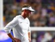 LSU head coach Lane Kiffin stands with his hands on his hips on the sideline during a game against Clemson.