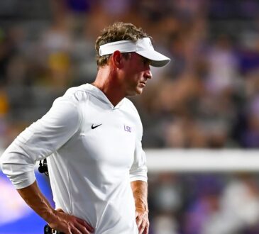 LSU head coach Lane Kiffin stands with his hands on his hips on the sideline during a game against Clemson.