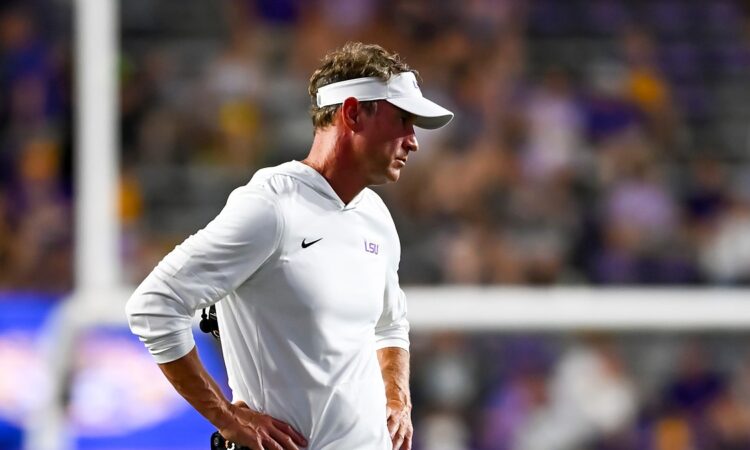 LSU head coach Lane Kiffin stands with his hands on his hips on the sideline during a game against Clemson.
